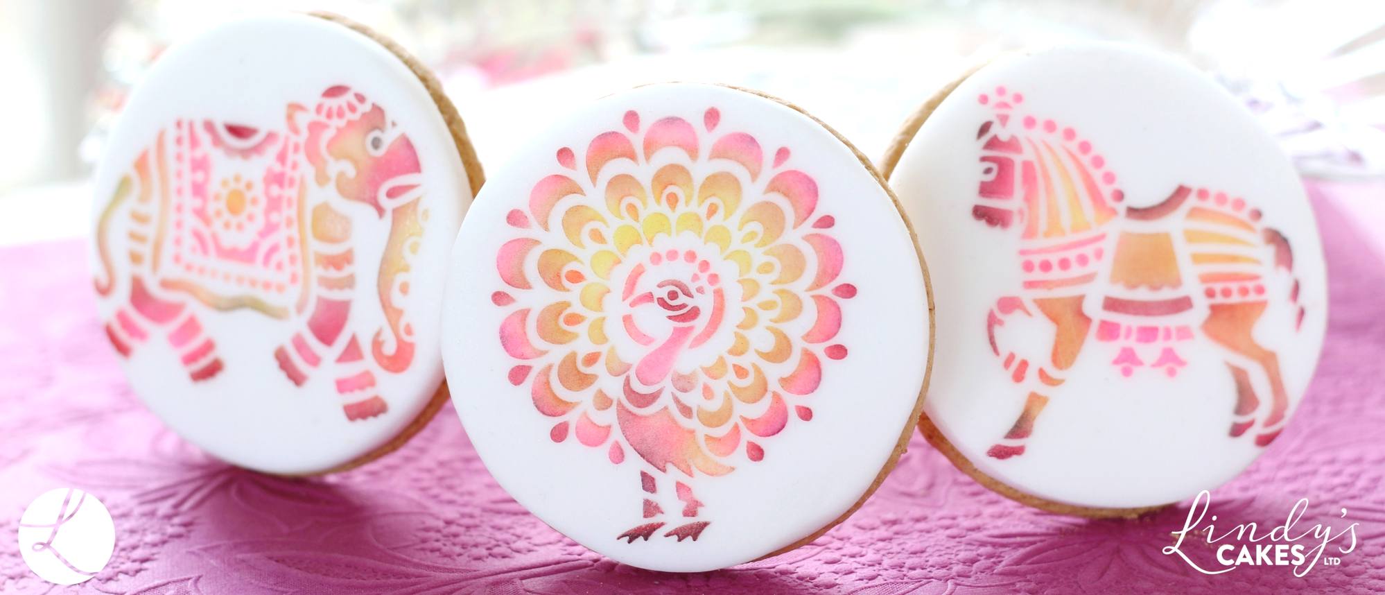 Stencilled pink peacock and other Indian animals on cookies