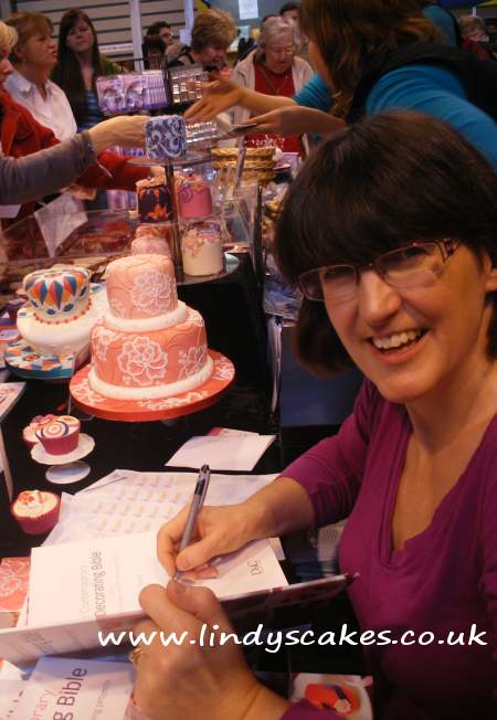 Lindy signing her new cake bible books