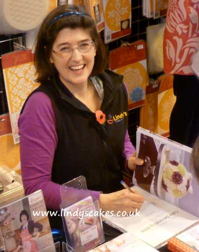 Lindy Smith signing books on the stand at the NEC 2012