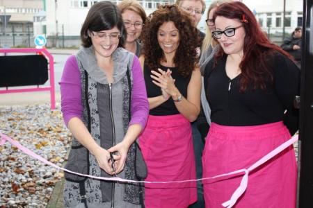 cutting the ribbon for new German cake decorating shop -  take one