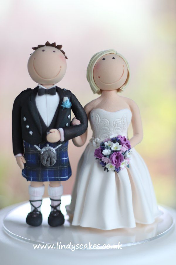 Scottish groom with his English rose hand-crafted cake topper