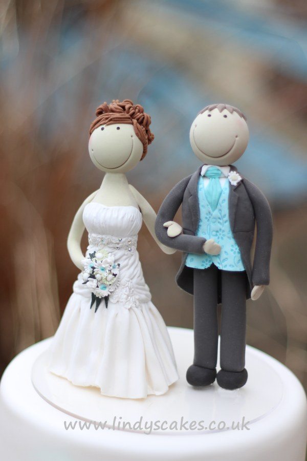 Bespoke bride and groom cake topper for an aqua themed wedding