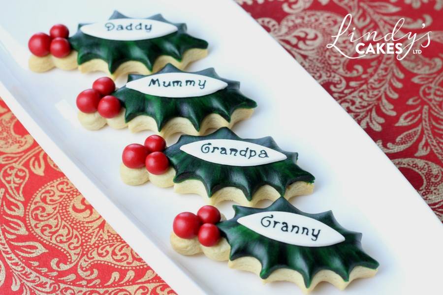 Christmas holly place name cookies by Lindy Smith as seen in the November issue of Cake Decoration and Sugarcraft magazine