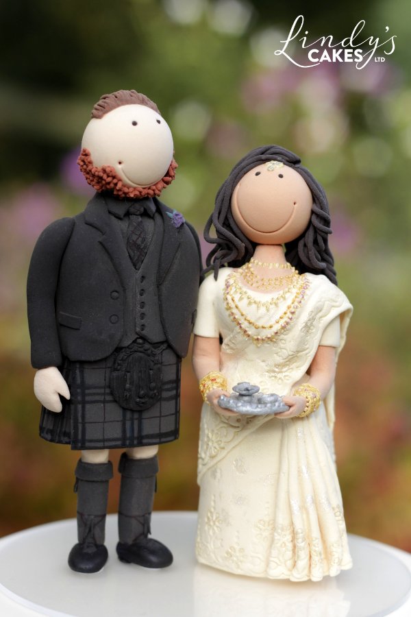 personalised bride and groom cake topper - scottish groom in a kilt and Indian bride in a sari
