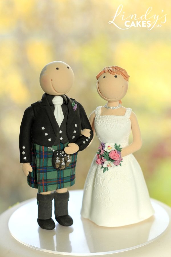 Bride and scottish groom cake topper - who doesn't love a man in a kilt!