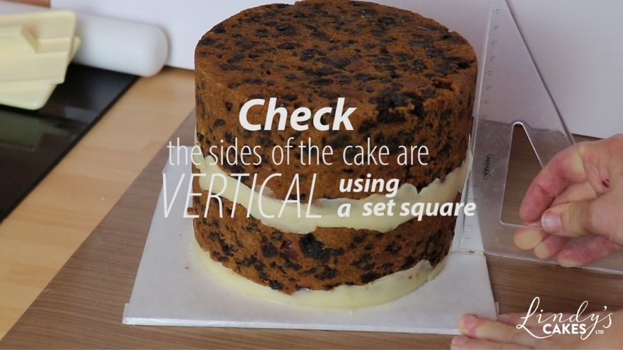 checking sides of cake are vertical