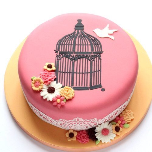 Cake stencilling techniques used to ad this lovely vintage birdcage to the top of this striking celebration cake